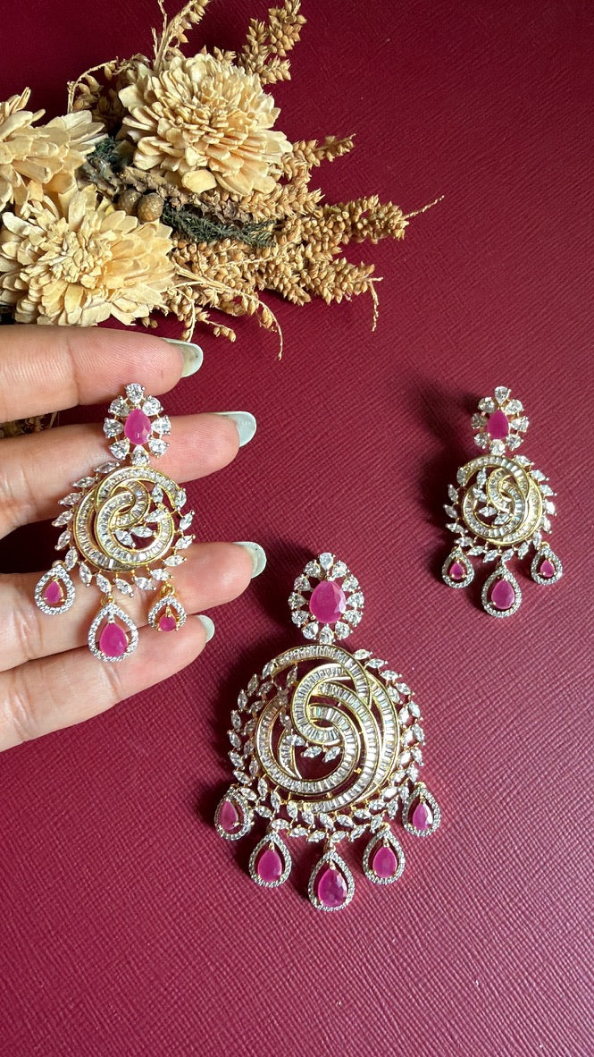Ramya earring held against the hand to show its scale next to the pendant