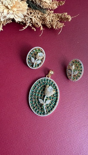 Nirali oval pendant set with emerald-green coloured stones and a white American Diamond rose, with matching rose studs