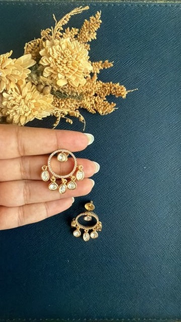 Vritika Kundan drop stud held in hand to show its ₹10-coin size, with the second stud below