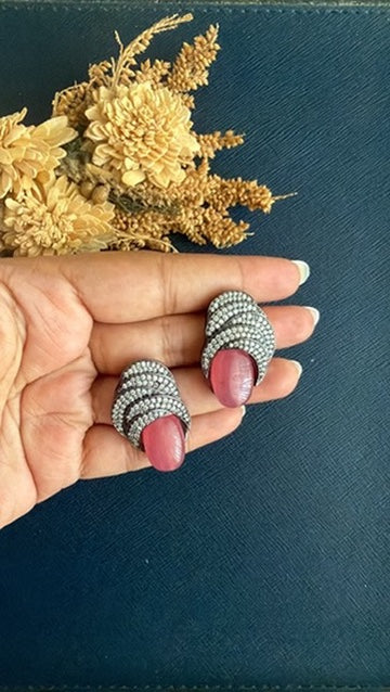 Pair of pink doublet stone Victorian statement studs held in the palm