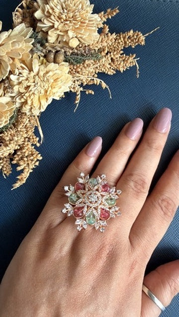 Eashea rose gold snowflake cocktail ring worn on the finger, with pink and mint-green stones and white American Diamond petals