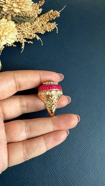 Side view of matt gold adjustable ring with domed ruby red stones and cut-work shank