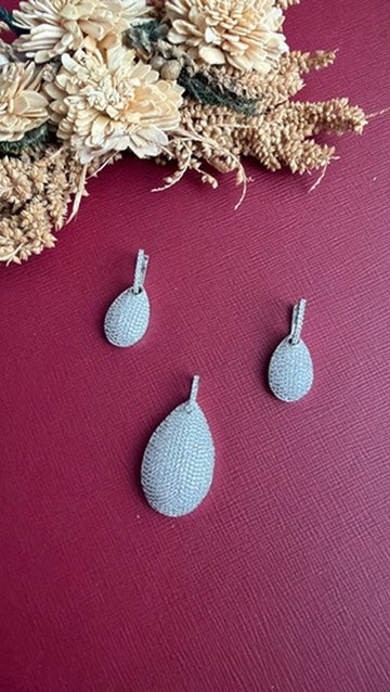 Nina silver-toned teardrop pendant fully covered in white American Diamond pavé, with matching huggie drop earrings