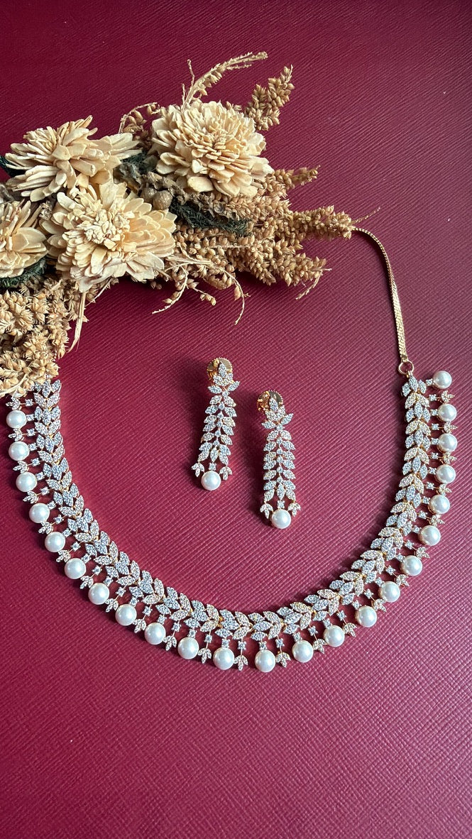 Irish American Diamond and pearl-look necklace and matching earrings flat lay