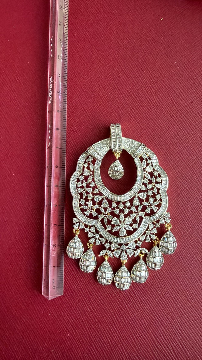 Close-up of brilliant white CZ stones on two-tone pendant
