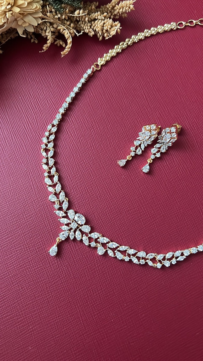 Manjeri white American Diamond leaf-vine necklace with off-centre marquise cluster and pear drop on a gold-toned setting, with matching 1-inch drop earrings