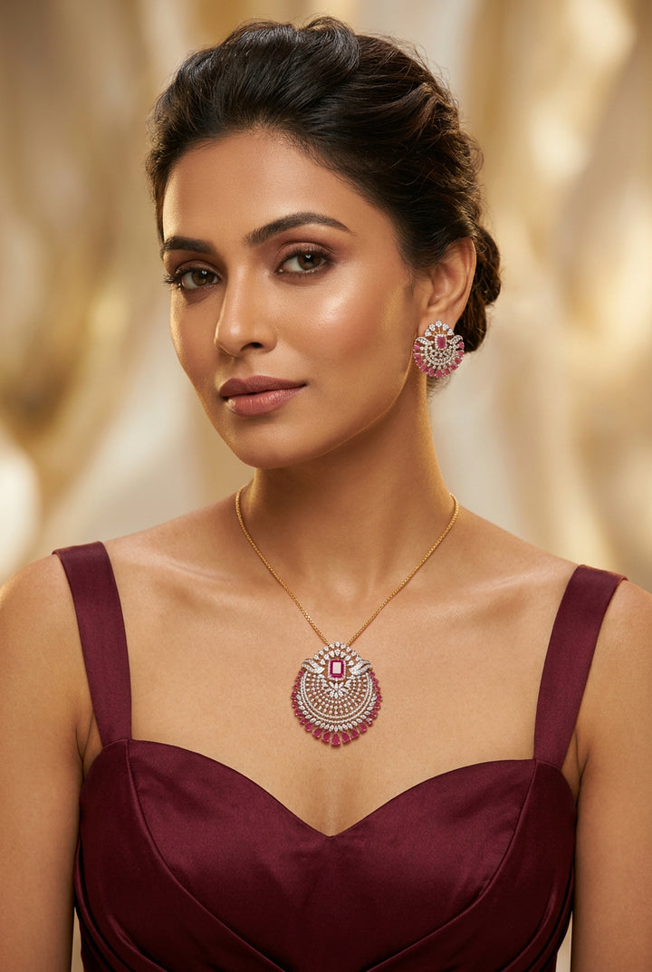 Rushika pendant set with ruby-pink centre stone, pink pear-drop border and white American Diamond on a gold-toned setting, with matching earrings