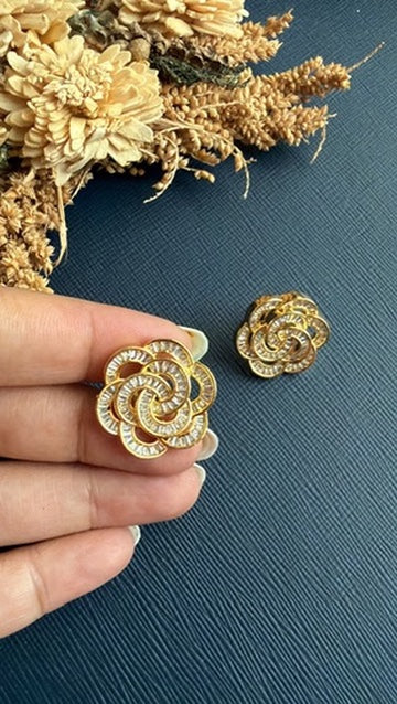 Damini American Diamond swirl stud held in hand to show its coin-size