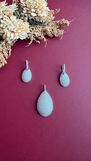 Nina white American Diamond pavé pendant set with teardrop earrings, flat lay
