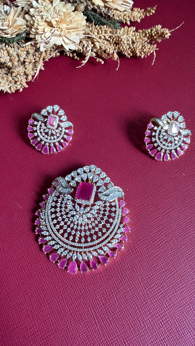 Rushika ruby-pink and white American Diamond pendant and earrings, angled view showing the fan-shaped stonework