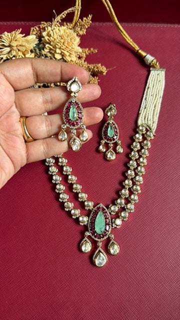 Green doublet stones and foil Kundan work on gold-tone necklace