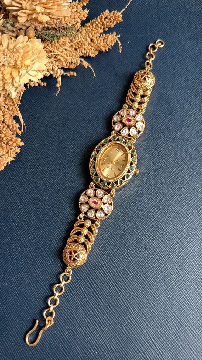 Archana Kundan watch bracelet laid flat, showing the oval dial, Kundan flower links and adjustable hook chain