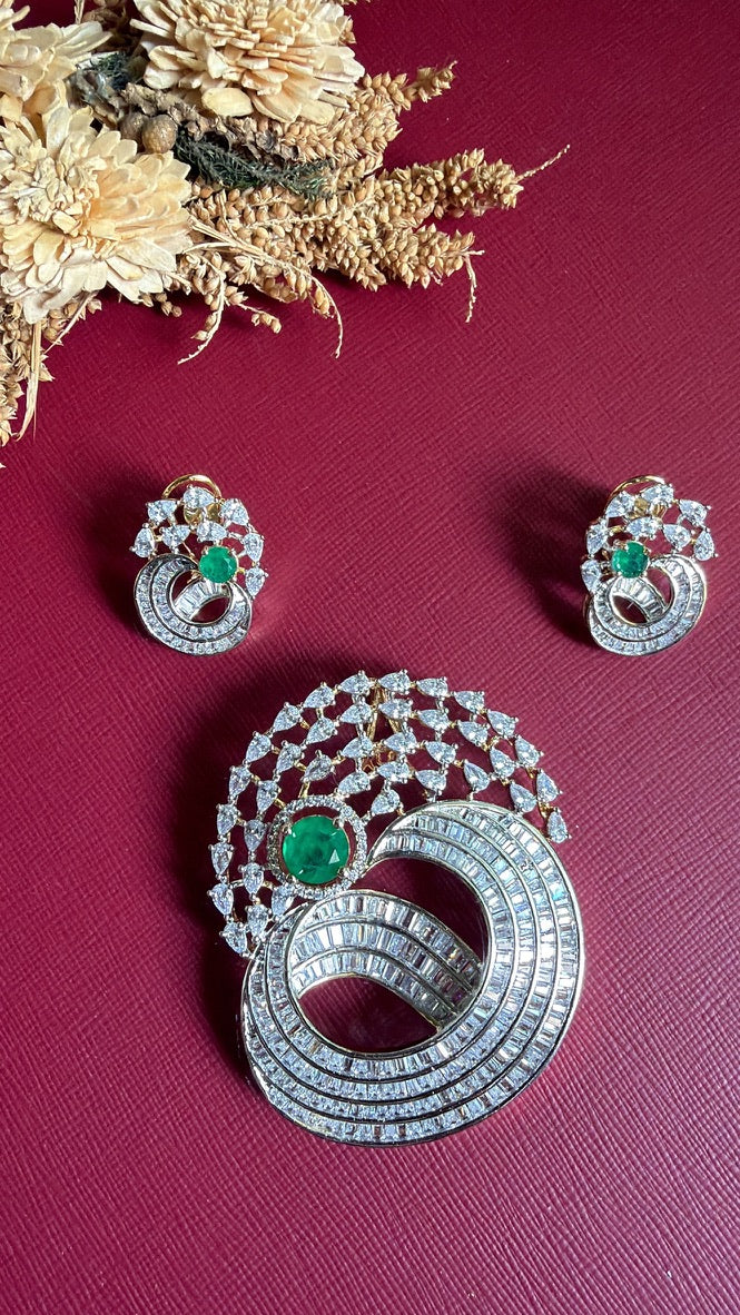 Afreen Diamond Pendant Set with green centre stone and swirl design, shown with matching earrings