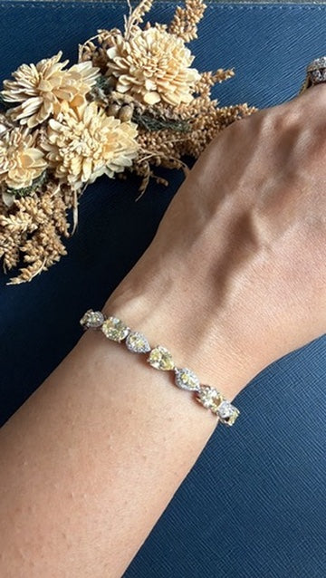 Butter yellow American Diamond tennis bracelet in a silver-tone rhodium finish
