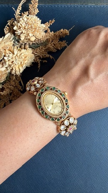 Archana Ethnic Watch Bracelet worn on the wrist – Kundan flowers and green stones around a gold-tone dial