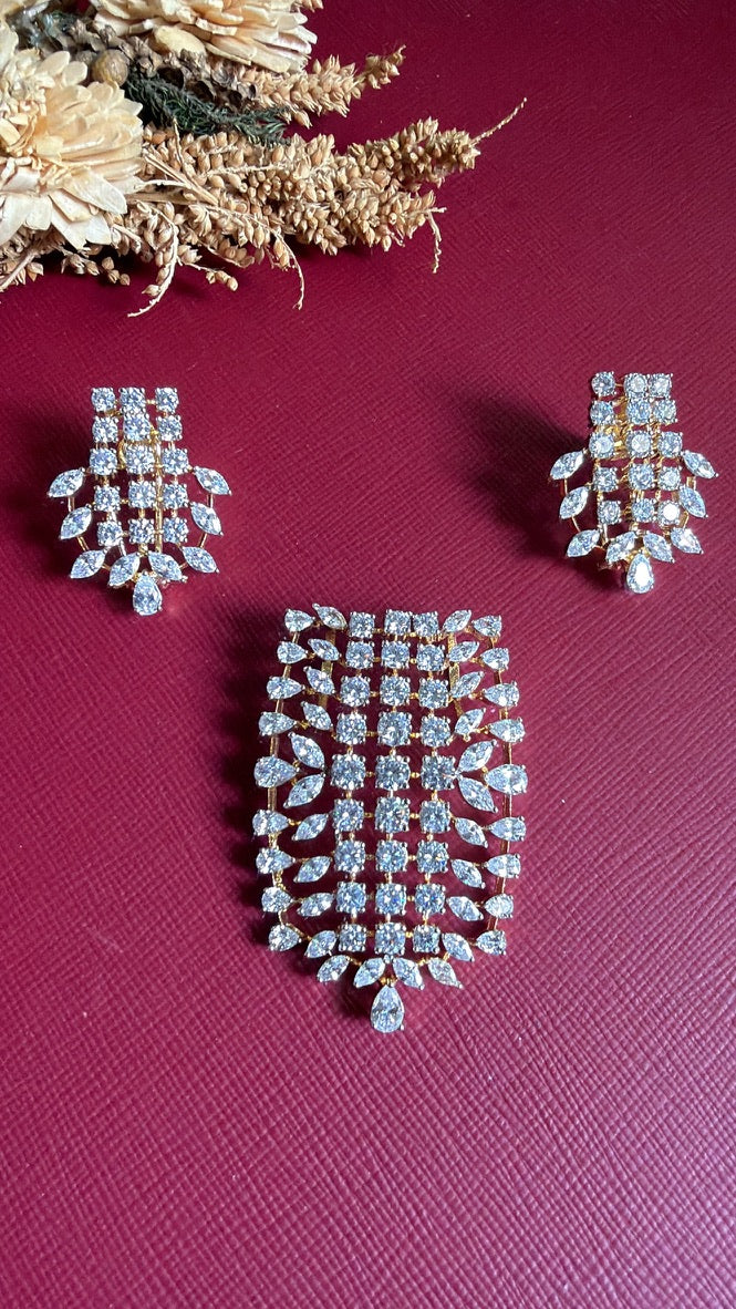 Saniya American Diamond pendant set: grid of round white CZ stones edged with marquise leaves and a pear drop, on a gold-toned setting, with matching earrings