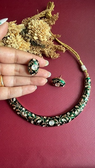 Anushree green meena oval studs held in hand with matching hasli