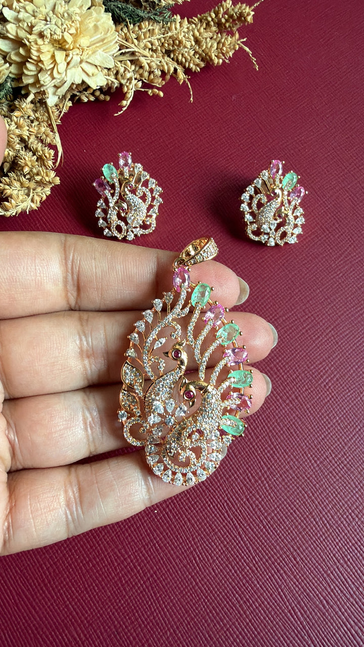 Emaan rose gold peacock pendant held in hand to show size