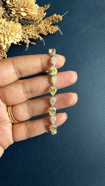 Close-up of the butter yellow AAA CZ stones along the Namra silver-tone band