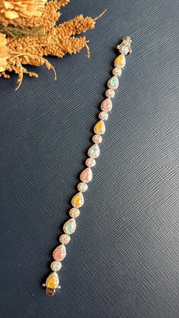 Close-up of the multicolour CZ stones set along the Malak silver-tone tennis bracelet