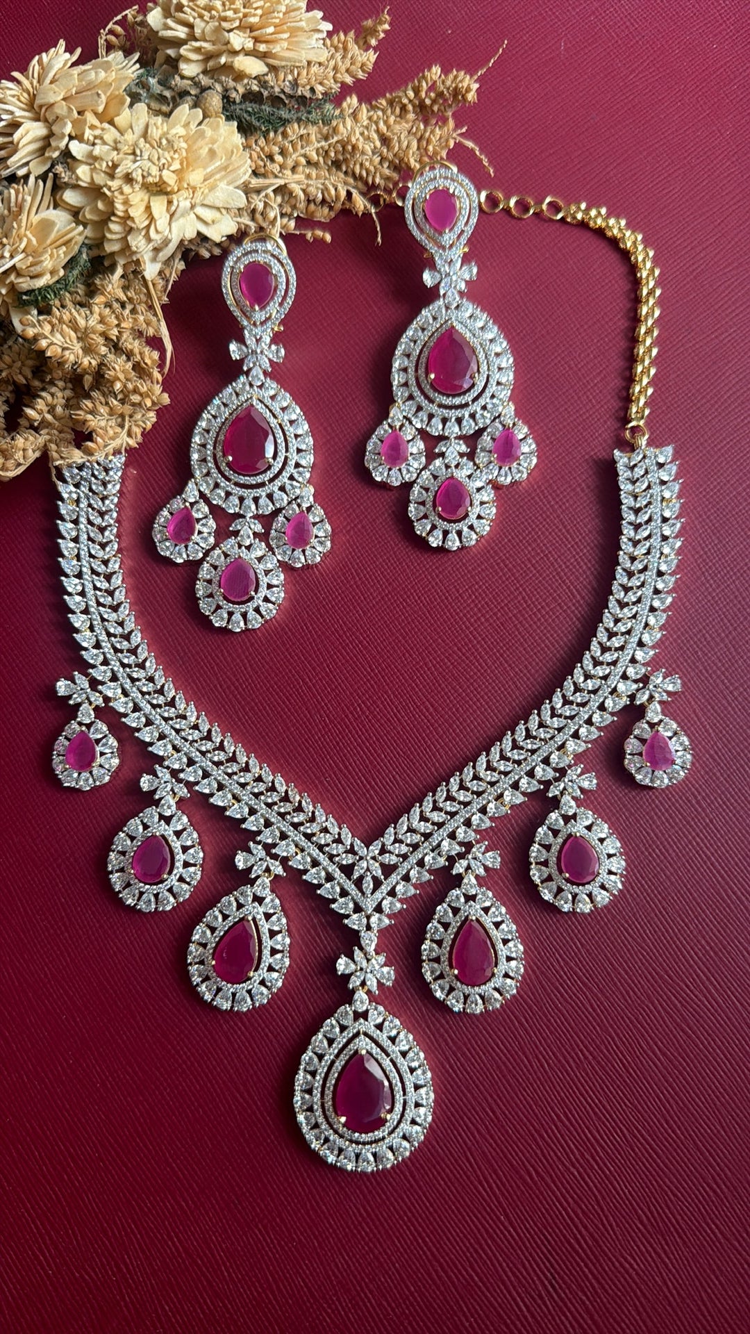 Supriya dual-tone American Diamond V necklace with seven ruby-pink teardrop drops