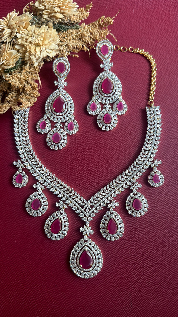 Supriya dual-tone American Diamond V necklace with seven ruby-pink teardrop drops