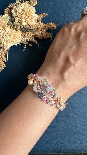 Chellan pastel stone and American Diamond bracelet on the wrist, rose gold-toned