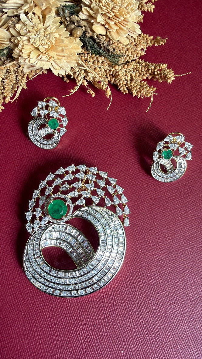 Afreen green pendant set flat lay – two-tone swirl pendant and matching screw-lock earrings