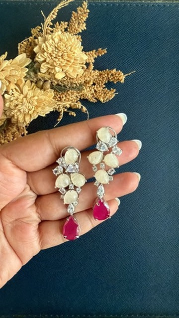 Suri doublet earrings held in hand to show 1.75 inch size