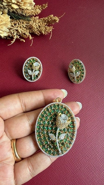 Nirali rose pendant held in hand to show its 2-inch size, with matching oval studs above