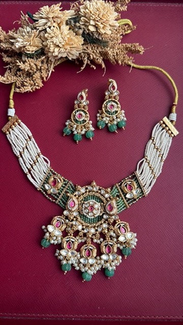Matching gold polish earrings from the Arvika green kundan necklace set