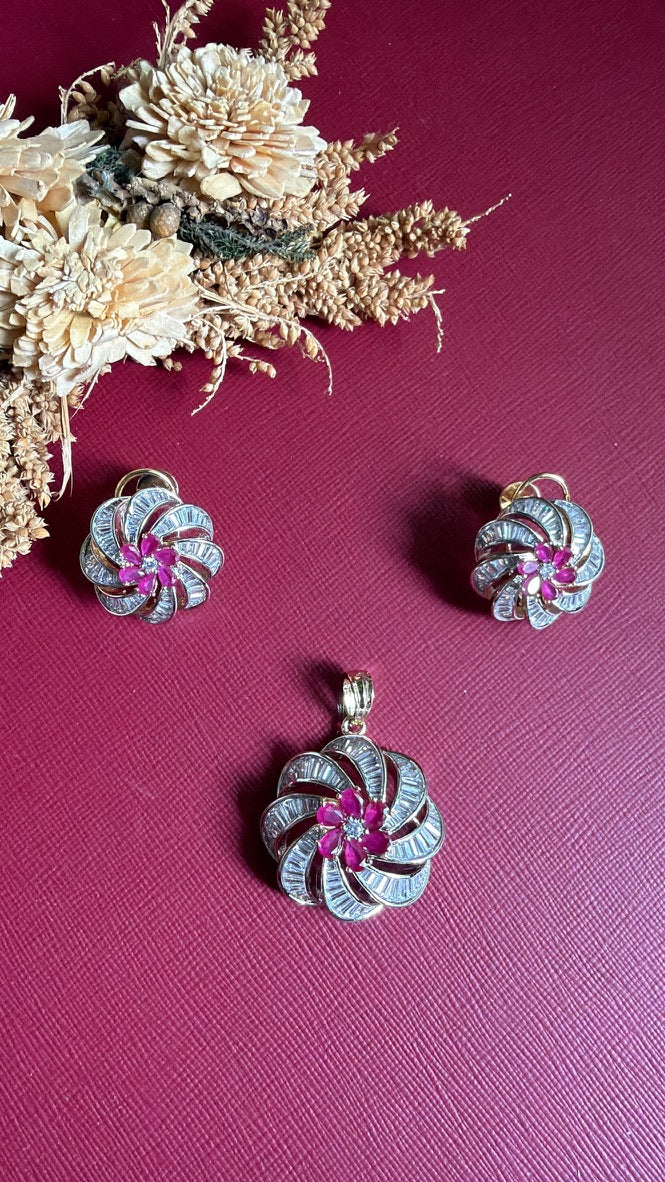 Mansi dual-tone swirl pendant with white baguette American Diamond and ruby-pink stone flower, with matching earrings