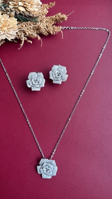 Roosy rose pendant set flat lay – American Diamond rose pendant on chain with matching rose studs