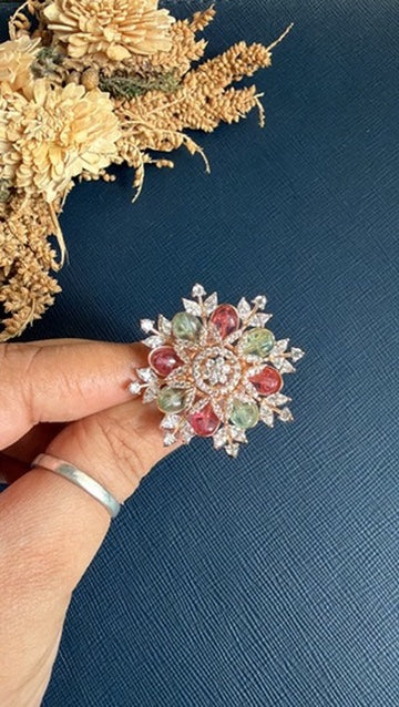 Eashea pastel stone cocktail ring held between fingers to show its size