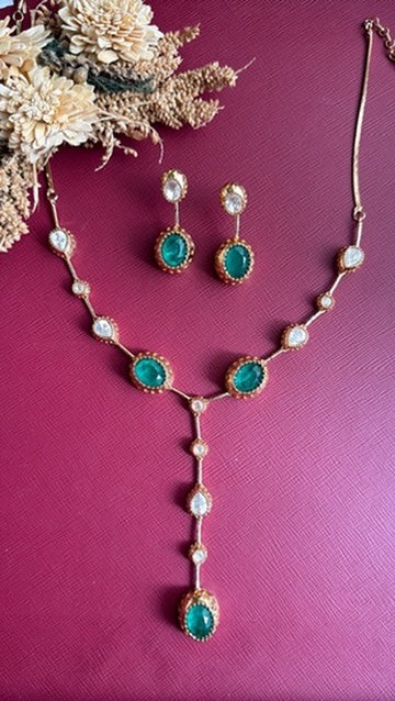 Abeer green stone lariat necklace set with Kundan-top drop earrings, flat lay