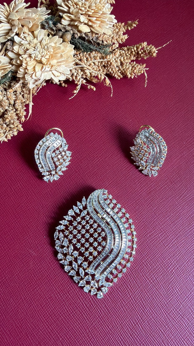 Sana dual-tone American Diamond leaf pendant with baguette wave and matching earrings