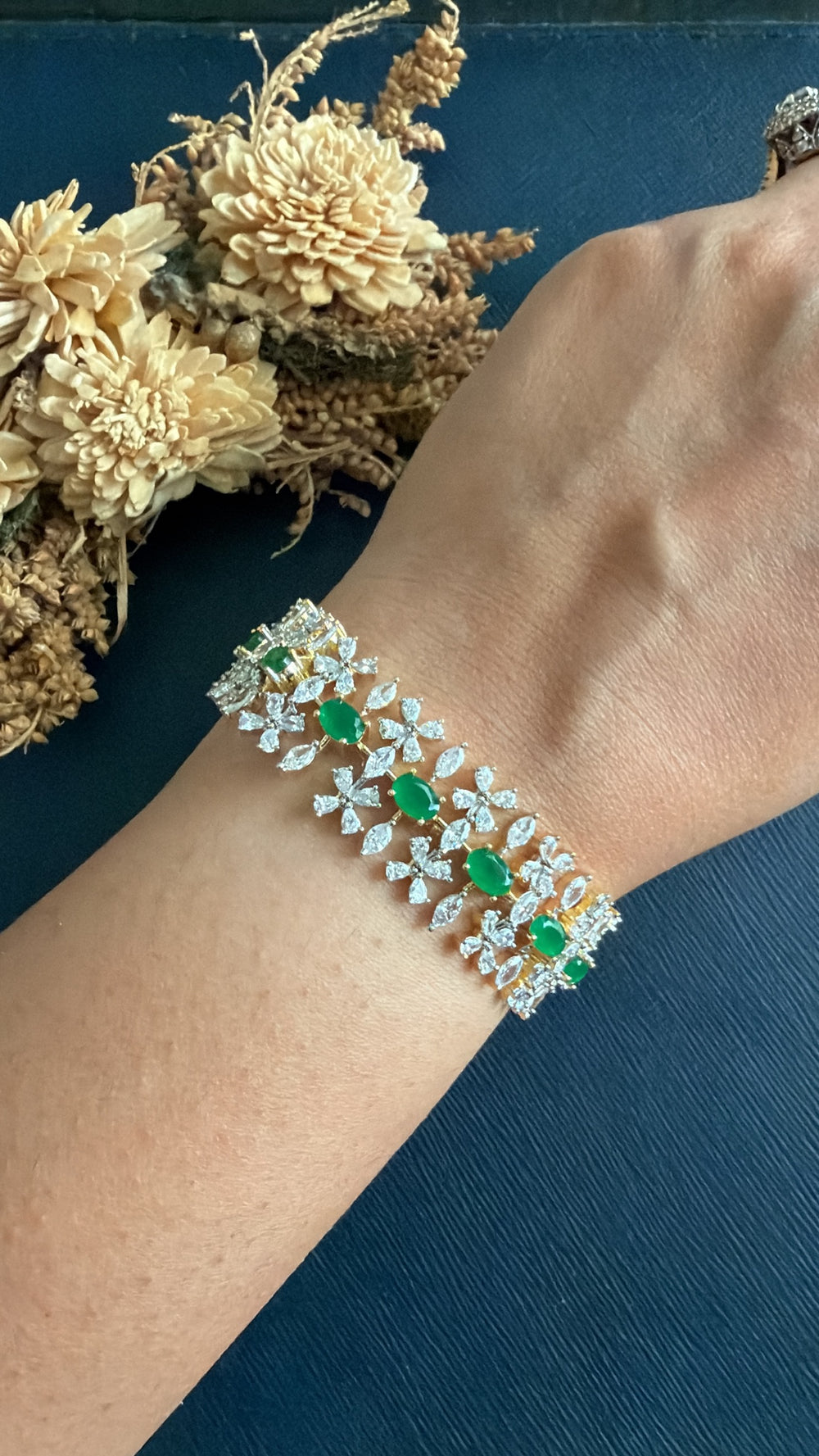 Rupam emerald-green CZ tennis bracelet worn on wrist, festive jewellery