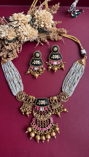 Ruhinka Pachi Kundan choker set shown with its matching earrings