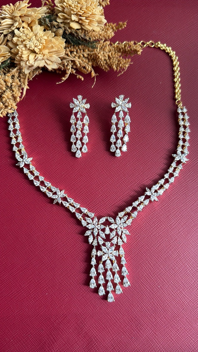 Jyosthna white American Diamond necklace and earrings, angled view of the pear-drop fringe