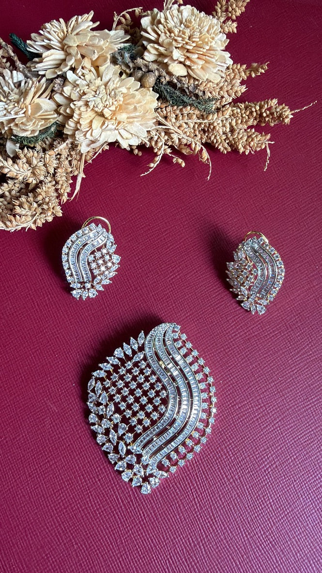 Sana American Diamond wave earring held in hand with matching pendant