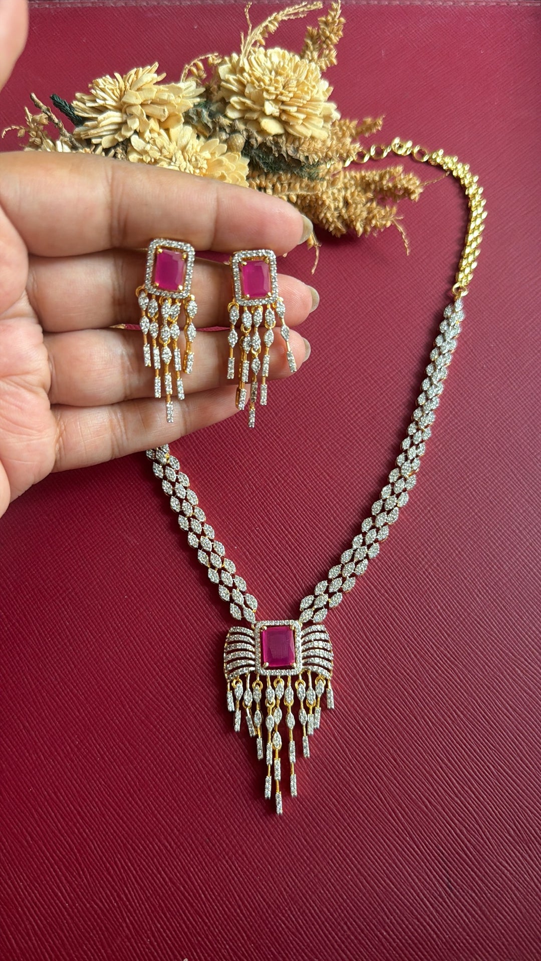 Khurmi dual-tone American Diamond necklace with rectangular ruby-pink stone and fringe drops