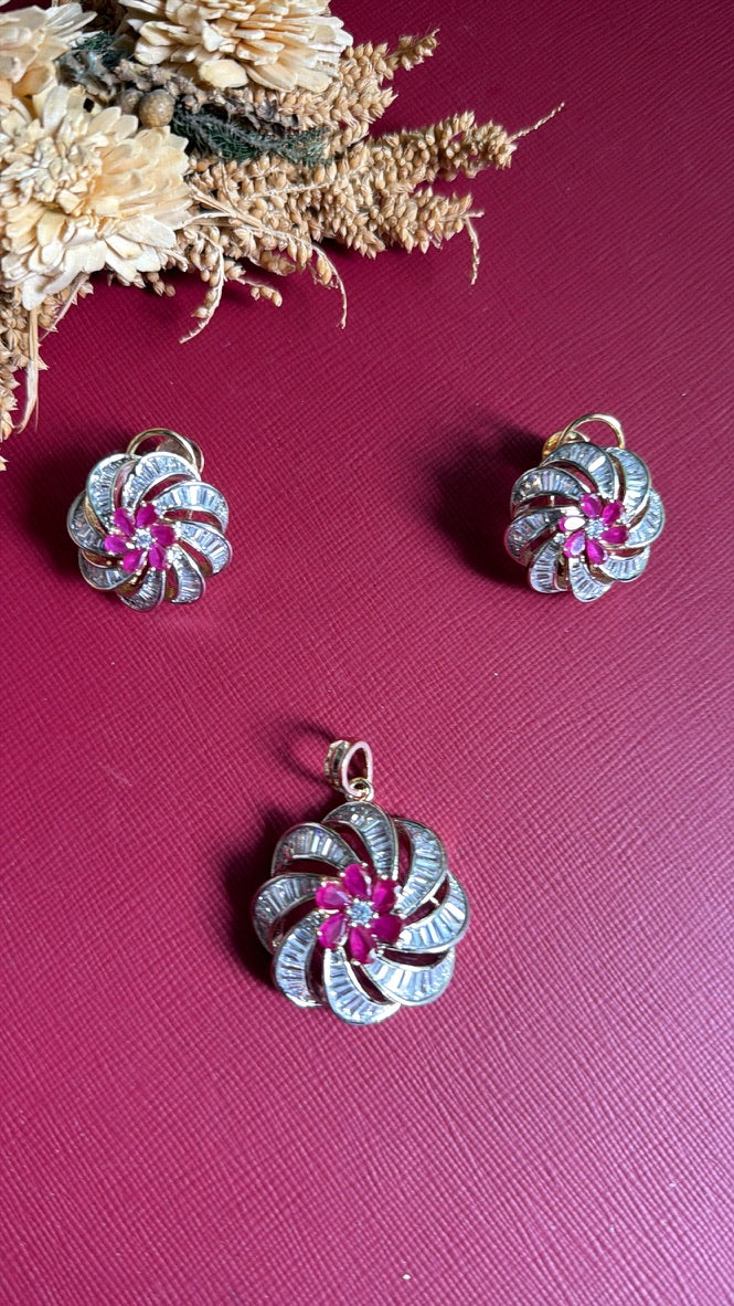 Mansi pinwheel pendant set in dual tone with ruby-pink centre flower, flat lay