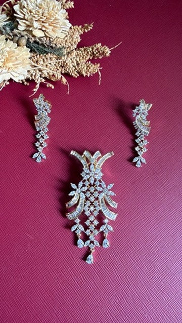 Sufiyana American Diamond pendant set: curved baguette bands, marquise flowers and pear drops on a gold-toned setting, with long matching drop earrings