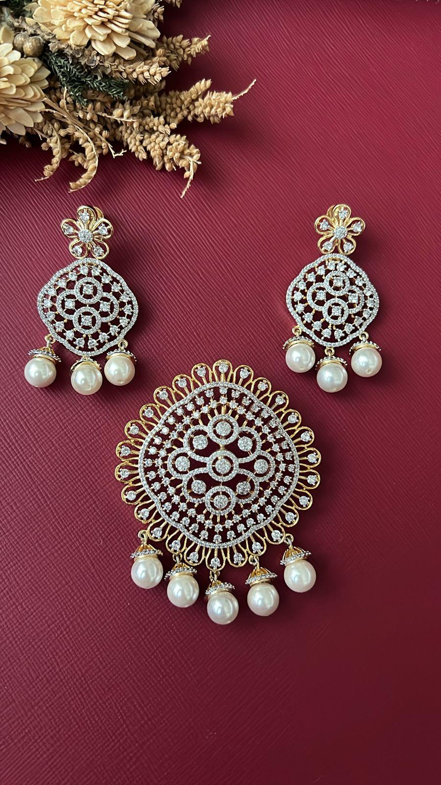 Floral lace pendant with white CZ stones and pearl-style beads, close-up
