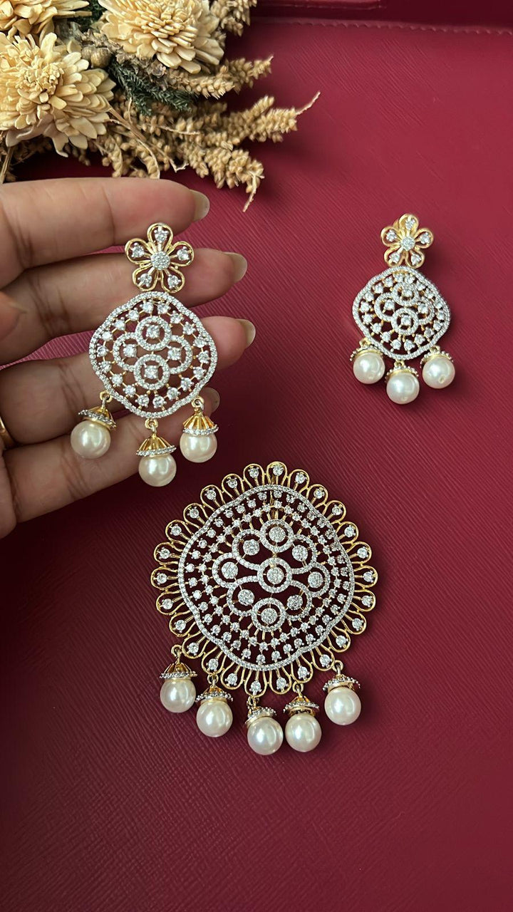Roma pearl fusion pendant set styled on red background with dried flowers